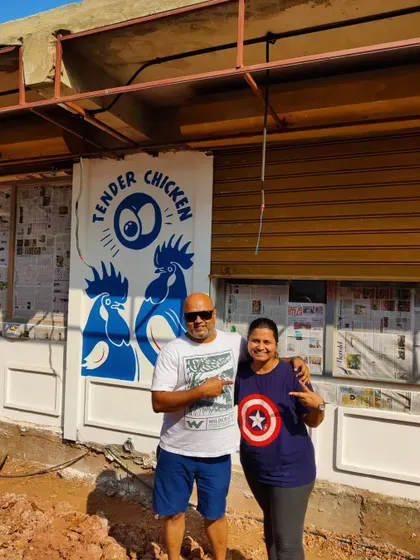 Posing with a happy client in front of the completed exterior mural for their 'Tender Chicken' shop in Goa.