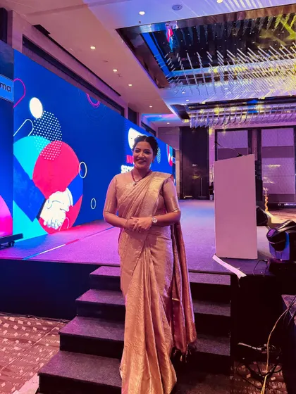 Another view of the stage for the Bharti AXA and Nuvama event. I am comfortable on large, modern stages with complex lighting and screen setups.