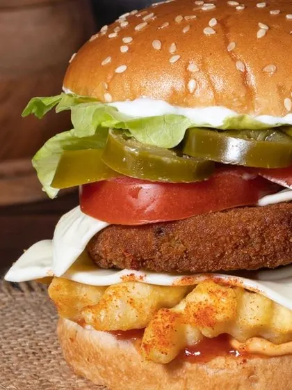 A close-up shot like this focuses on the details that make a burger tempting: the melted cheese, the crisp lettuce, and the toasted sesame seed bun. It’s all about the texture.