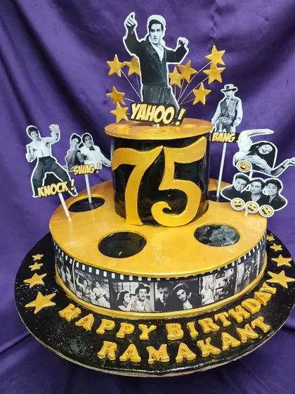 A trip down memory lane with this Bollywood retro theme cake. Celebrating a 75th birthday, this cake features film reels and cutouts of yesteryear's movie stars, perfect for a fan of classic Indian cinema.