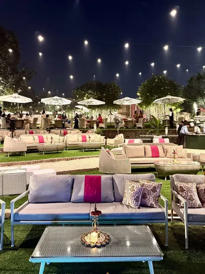 A closer look at the guest seating on the lawns, with modern grey and pink sofas, showcasing a contemporary and comfortable setup for any event.
