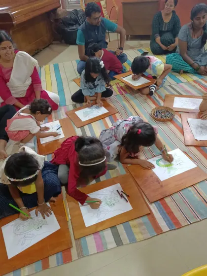Another view of the children's intense focus during the drawing activity.