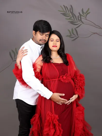 A serene embrace. This couple's portrait captures a quiet moment of connection, with the mom-to-be looking peaceful in her partner's arms.