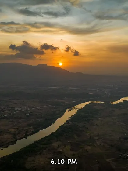 The sun is a perfect golden orb at 6:10 PM, hanging in the sky over the hazy landscape.