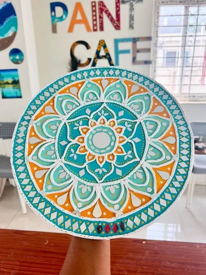 Another beautiful example of a finished Lippan art piece from a workshop, with a bright orange and teal color scheme.