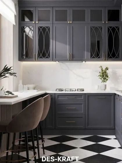 A classic black and white checkered floor provides a timeless foundation for this modern kitchen. We designed custom dark navy cabinetry with elegant glass and brass details, creating a sophisticated culinary space that is perfect for both cooking and entertaining.