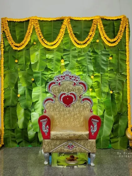 I love working with traditional elements to create something beautiful. This backdrop uses fresh banana leaves and bright yellow marigold garlands, a perfect and auspicious setup for ceremonies like a baby shower or a naming ceremony.