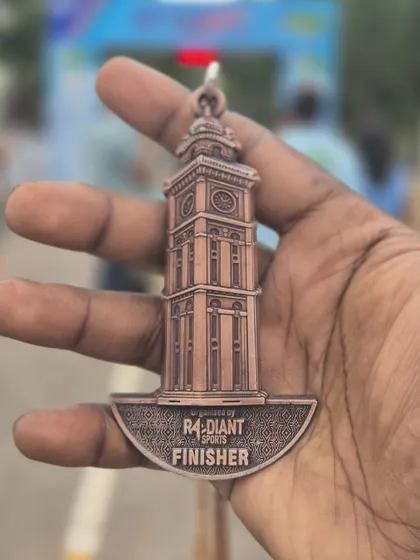 A close up of the beautifully designed finisher medal from the Radiant Sports Mysuru Run. A symbol of hard work and perseverance.