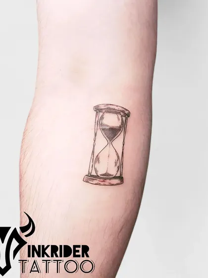An hourglass tattoo, symbolizing the passage of time. This small, detailed piece is a reminder to make every moment count.