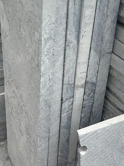 Stacks of finished stone slabs, showing the clean, cut edges.