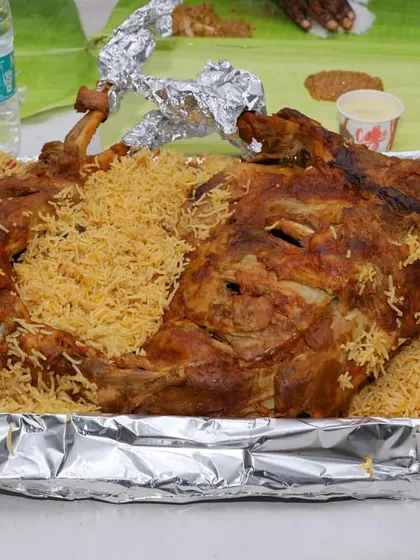 A full roasted mutton served on a bed of fragrant biryani. This is the ultimate centerpiece for a grand non-vegetarian wedding feast.