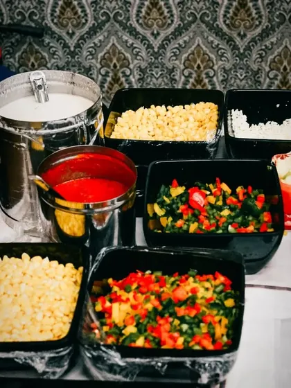 Here is a look at our pasta station ingredients, ready for a party. We use fresh corn, bell peppers, and other veggies to ensure every bowl is delicious and wholesome.