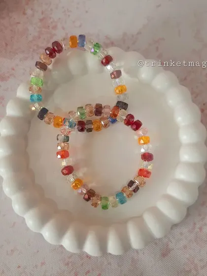 A pair of simple yet beautiful multi-colored crystal bead bracelets. The faceted beads catch the light and add a touch of sparkle to your wrist.
