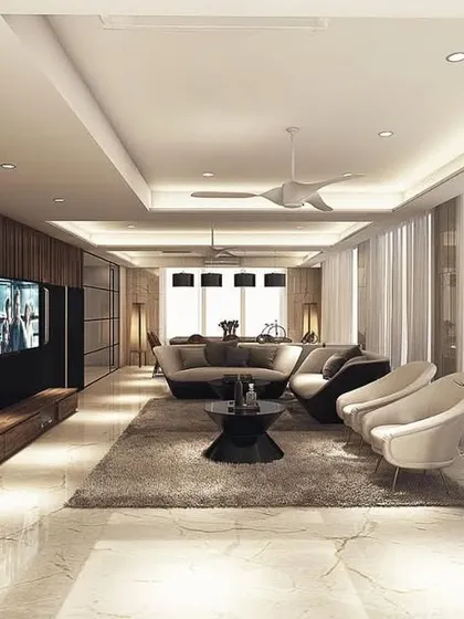 The full view of the penthouse living room, designed to be long and spacious. A dark wood media wall and bookshelf anchor one end, while floor-to-ceiling windows flood the space with light.
