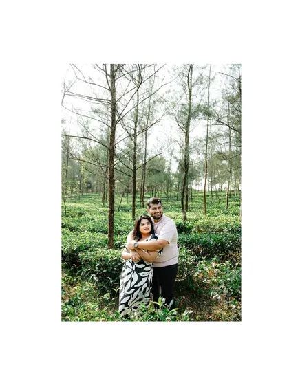 A full-length portrait of a couple embracing in a pine forest, capturing the tranquility of the location.