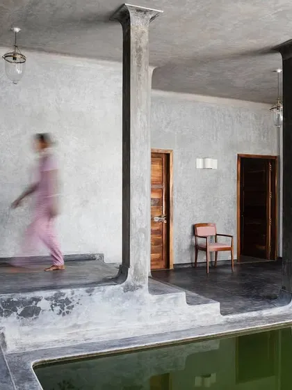 A moment of movement along the corridor of the main villa at Jalakara, with its distinctive columns framing the lily pond.