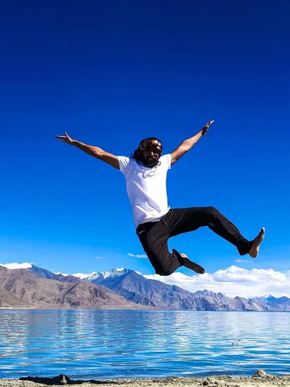 A wide-armed jump, embracing the incredible Himalayan landscape.