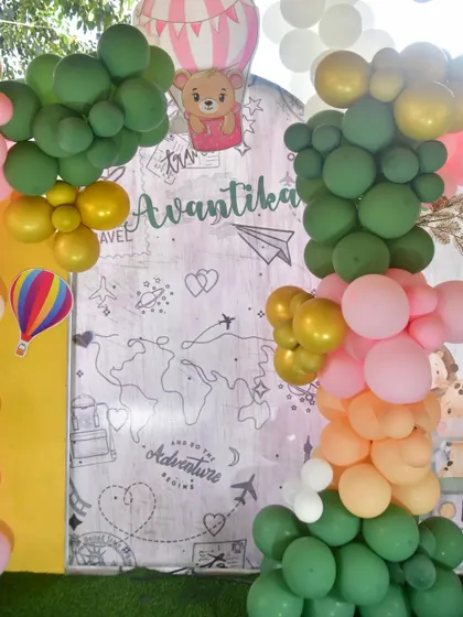 A detail of the world map backdrop with colorful balloon garlands.