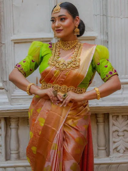 A close-up of the model, showing the intricate Vaddanam and layered necklaces.