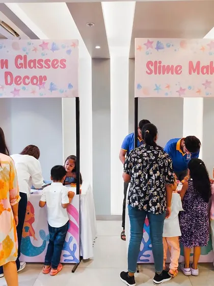 Activity stalls for a mermaid-themed party, offering sunglasses decorating and slime making. I always tailor the activities to fit the party's theme.