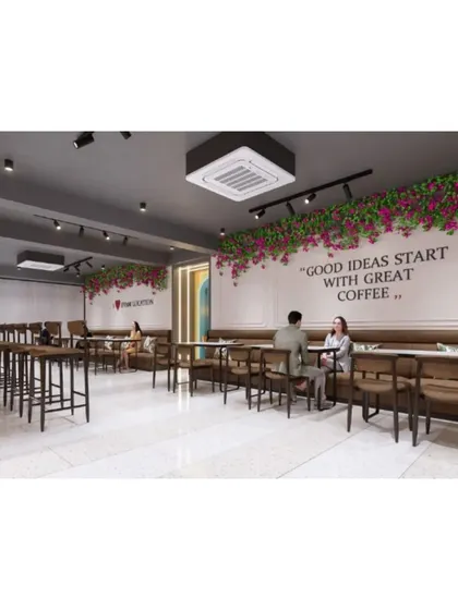 Another view of the main dining area, showing the floral installations and wall quotes that add personality to the space.