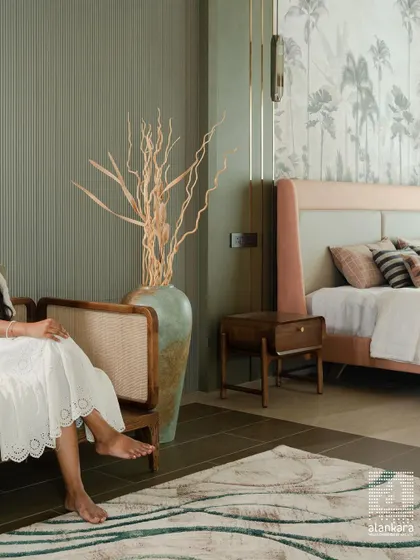 A serene bedroom corner where I combined a custom cane-backed bench with a soft, nature-inspired color palette. The fluted green wall and botanical wallpaper add layers of texture and tranquility.