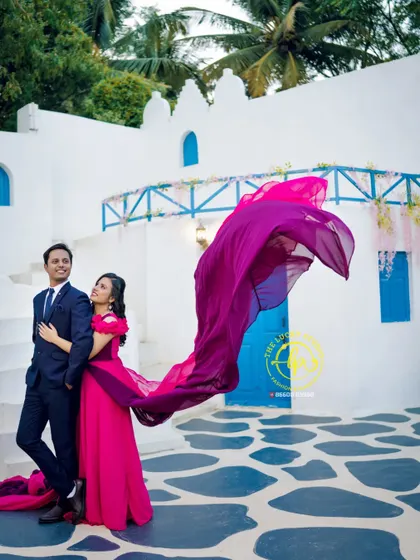 This vibrant pink and purple gown with a flying trail is one of my popular rental options for pre-wedding shoots. I styled it with a classic navy suit for a timeless couple's look.