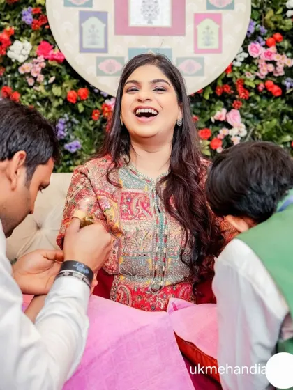 A candid shot of a bride's happy reaction during her mehandi application. These are the moments I cherish as an artist.