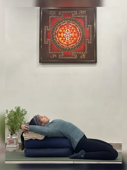In this supported Supta Virasana (Reclining Hero Pose), the mind can touch even the remotest parts of the body. This deep internal awareness brings a profound sense of peace and integration.