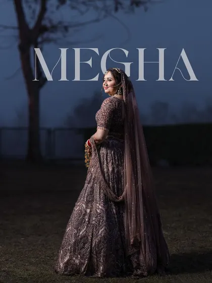 A stunning outdoor bridal portrait at dusk. The deep colors of her lehenga and the moody lighting create a dramatic and beautiful image, with the text overlay adding a modern, editorial feel.