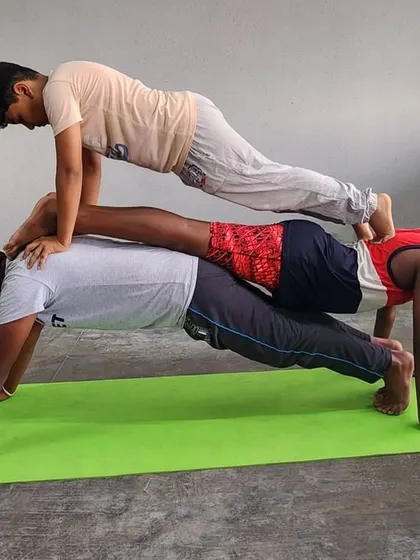 This variation of the plank stack shows how different body positions can be used to create unique and challenging group poses.