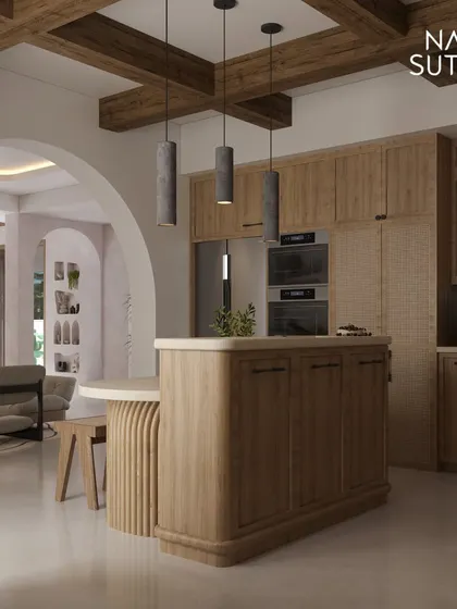The kitchen in our Minimal Organic Mediterranean project features warm wood cabinetry, a rounded island, and rustic ceiling beams. It's a functional space that feels inviting and blends seamlessly with the living area.