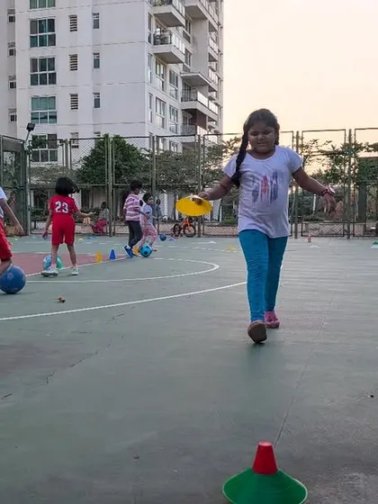 A girl runs confidently across the court during a multi-sport session. We offer a variety of after-school activities to keep kids active, healthy, and away from screens.
