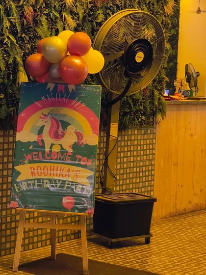 A whimsical welcome board for Roohika's magical unicorn-themed first birthday party, setting the tone for the celebration right from the entrance.