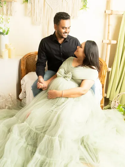 An intimate moment in our boho setup. The soft green gown complements the natural tones of the decor, creating a serene and romantic atmosphere.