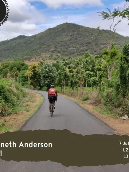 A cyclist enjoys the winding roads of the 'Kenneth Anderson Trail', a route known for its lush greenery and rolling hills.