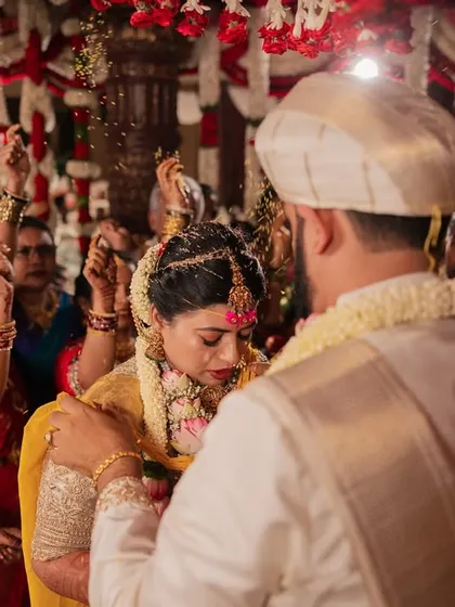 The moment of tying the mangalsutra, with family members showering the couple with blessings and rice.