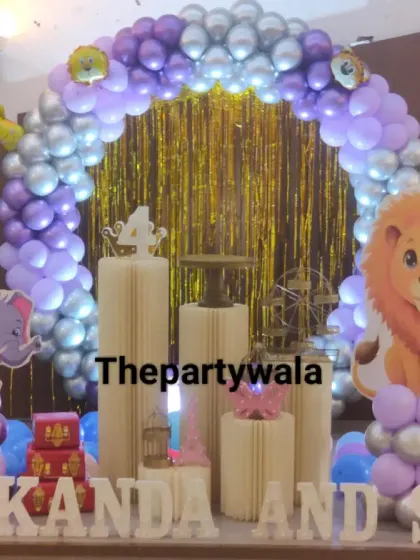 A jungle theme with a purple and silver twist. This setup features elephant and lion cutouts against a gold shimmer backdrop.