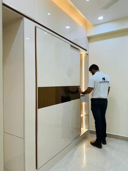 Another view of the off-white and gold sliding wardrobe. The smooth sliding mechanism and high-quality finish are details that I always focus on for a premium feel.