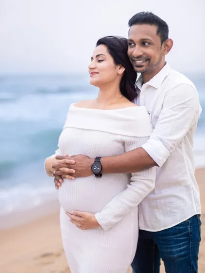 Looking out at the waves together, dreaming of the future. This is a beautiful, hopeful portrait of a couple on the verge of parenthood.