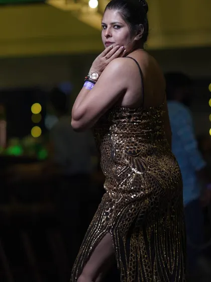 Another pose in the sequin dress, showing off its thigh-slit detail. I design clothes that are meant to be seen and admired.