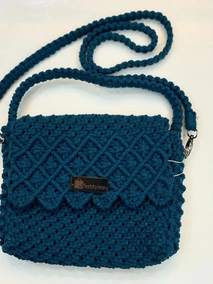 Another look at the teal scalloped flap bag, showing its coiled strap.