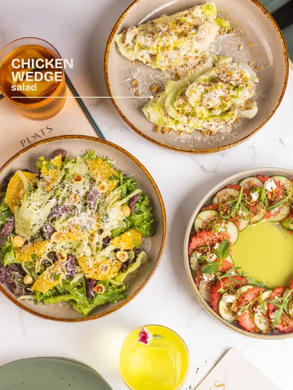 Focusing on the Chicken Wedge salad, with its creamy dressing and generous topping of parmesan crumble.