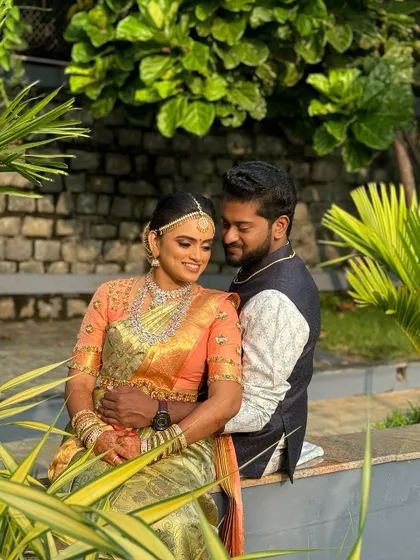 A romantic moment between the happy couple. The bride's soft glam makeup and traditional jewelry create a look of pure elegance, perfect for these cherished wedding photos.