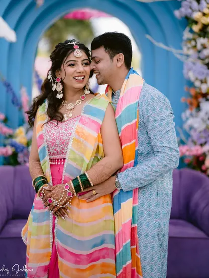 A whispered secret and a shared laugh during the Haldi ceremony.