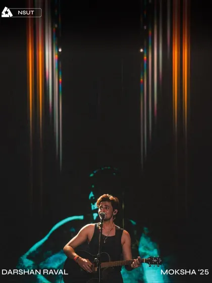 An artistic shot of Darshan Raval during his headline set at Moksha '25, with our custom visuals creating a powerful backdrop.