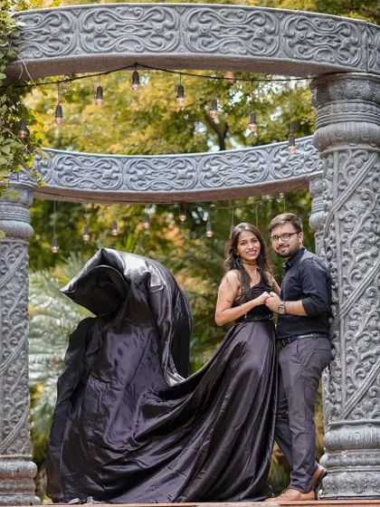 A dramatic couple portrait featuring our black satin trail gown. The flowing fabric adds a sense of motion and grandeur, perfect for creating artistic pre-wedding memories.