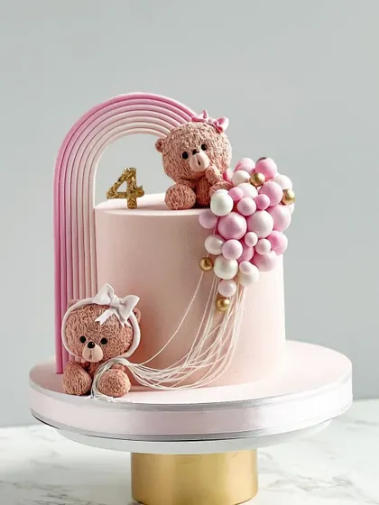 A pretty pastel pink teddy bear cake for a fourth birthday.
