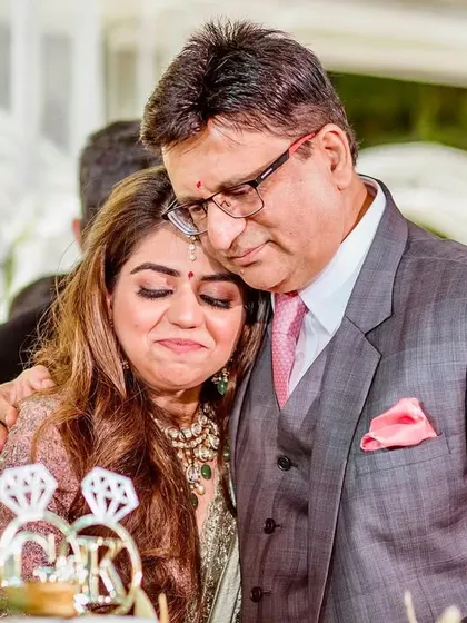 An emotional hug between the bride and her father during the engagement cake cutting. A moment of pure, unfiltered parental love.