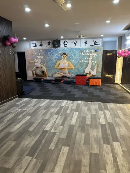 Our yoga and stretch area, a calm space within our vibrant studio. We believe in a holistic approach to fitness, and this corner is designed for mindfulness and recovery.